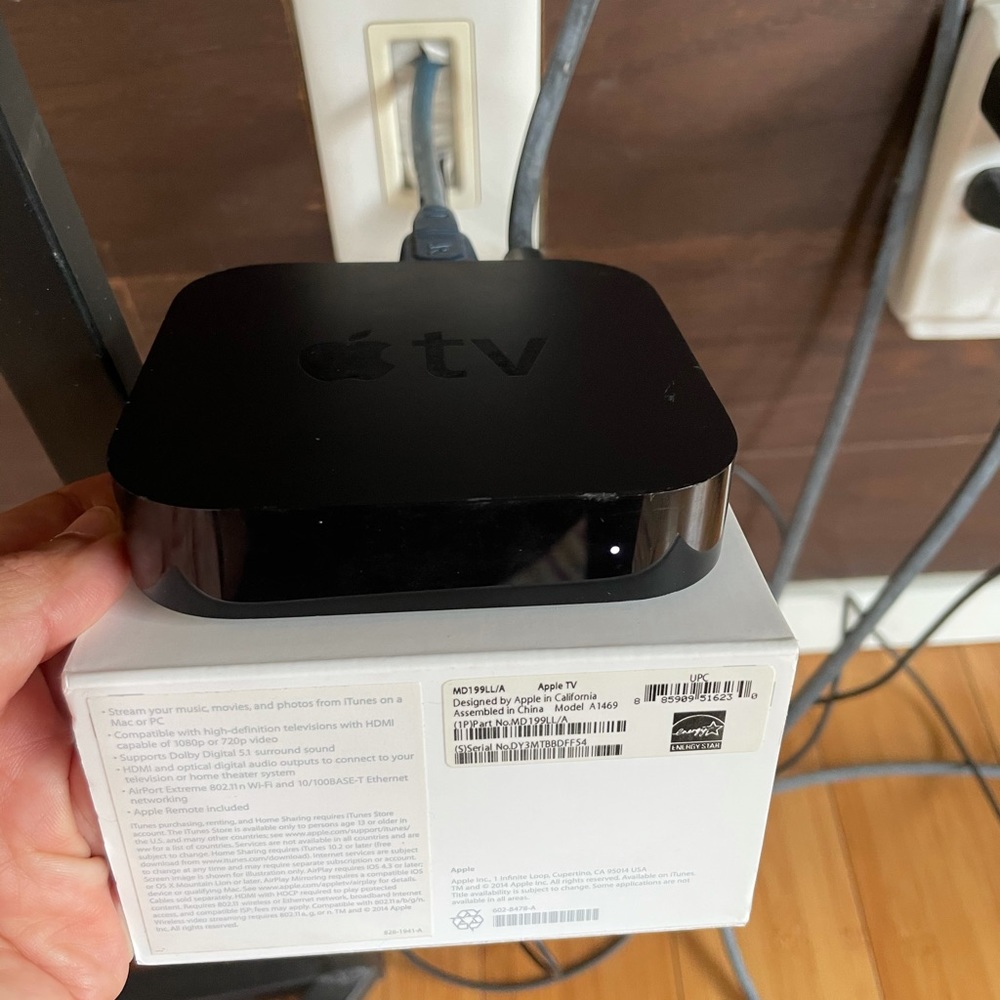 Apple TV with cord, remote, original packaging.